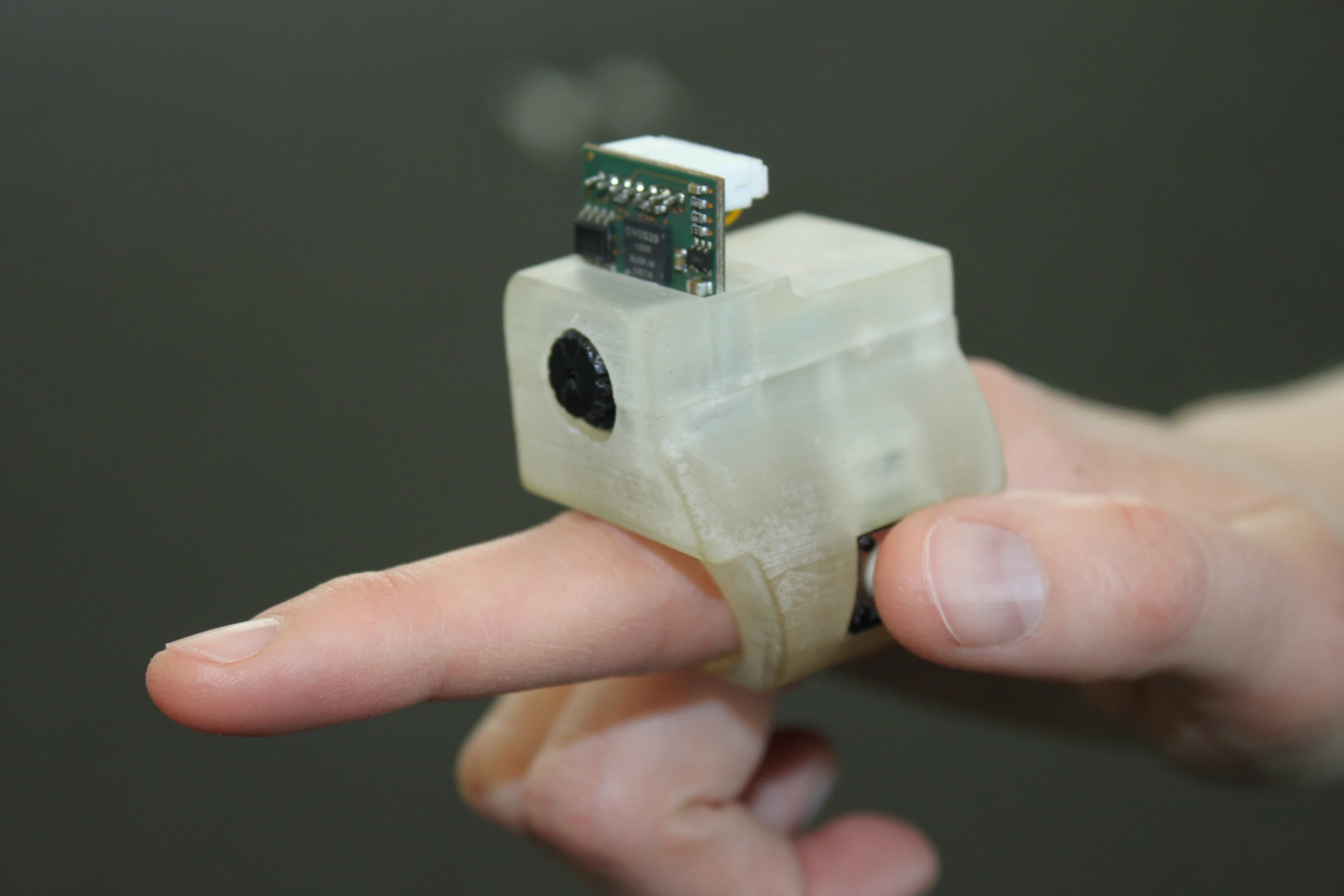 The EyeRing features a 3D-printed ABS nylon outer housing containing a small VGA camera unit, a 16 MHz AVR processor, a Bluetooth radio module and a 3.7V Li-ion battery