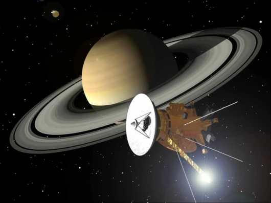 This is an artist's impression of the Cassini-Huygens spacecraft approaching Saturn and its magnificent rings. The glint of light behind the magnetometer boom at the bottom of the spacecraft is a reflection of the Sun. Image: NASA