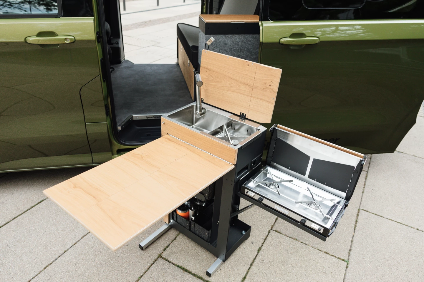 The kitchen block also removes completely to stand on feet for cooking away from the van
