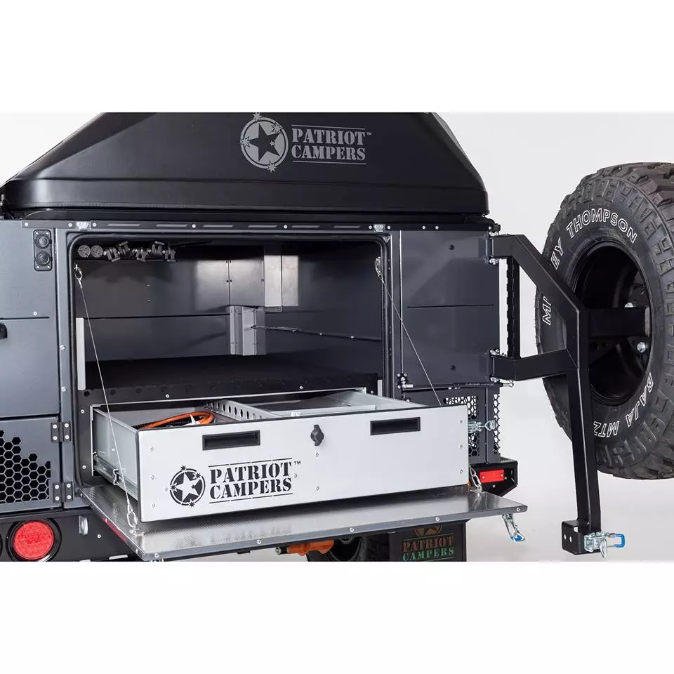 The rear cargo area features a large compartment for loading bags and large gear