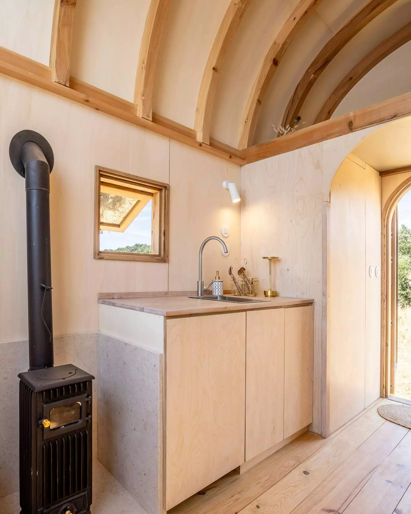 The Terra m1_Tiny House on Wheels' kitchen is small and simple, reflecting its use as a vacation home