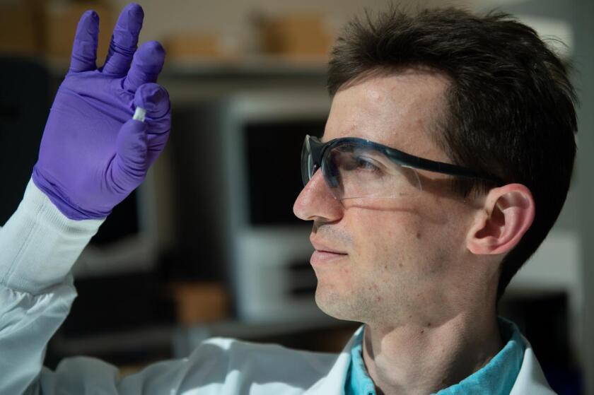 Sean Bittner examines a sample of the material