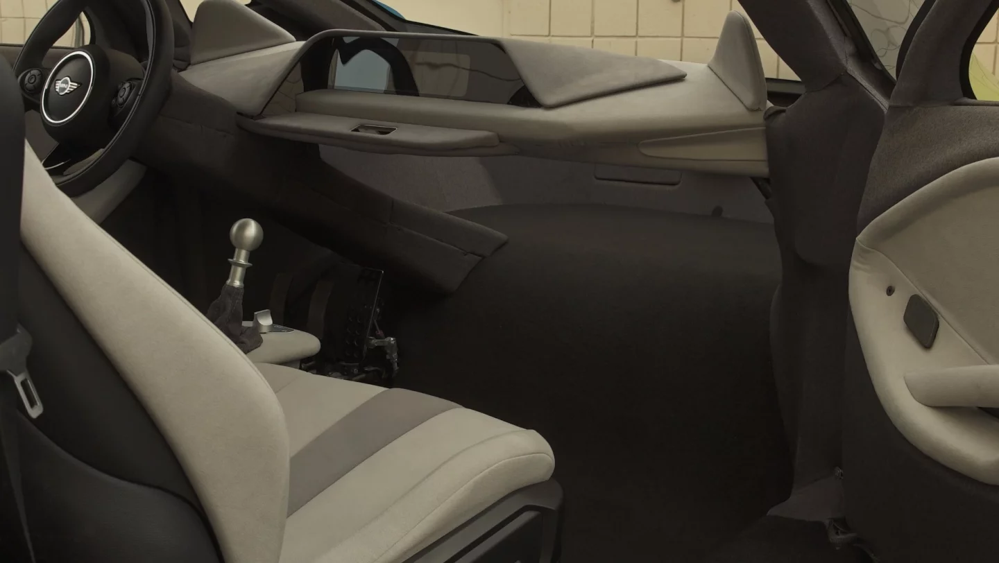 The simple, open interior features a floating dashboard and two rows of seating