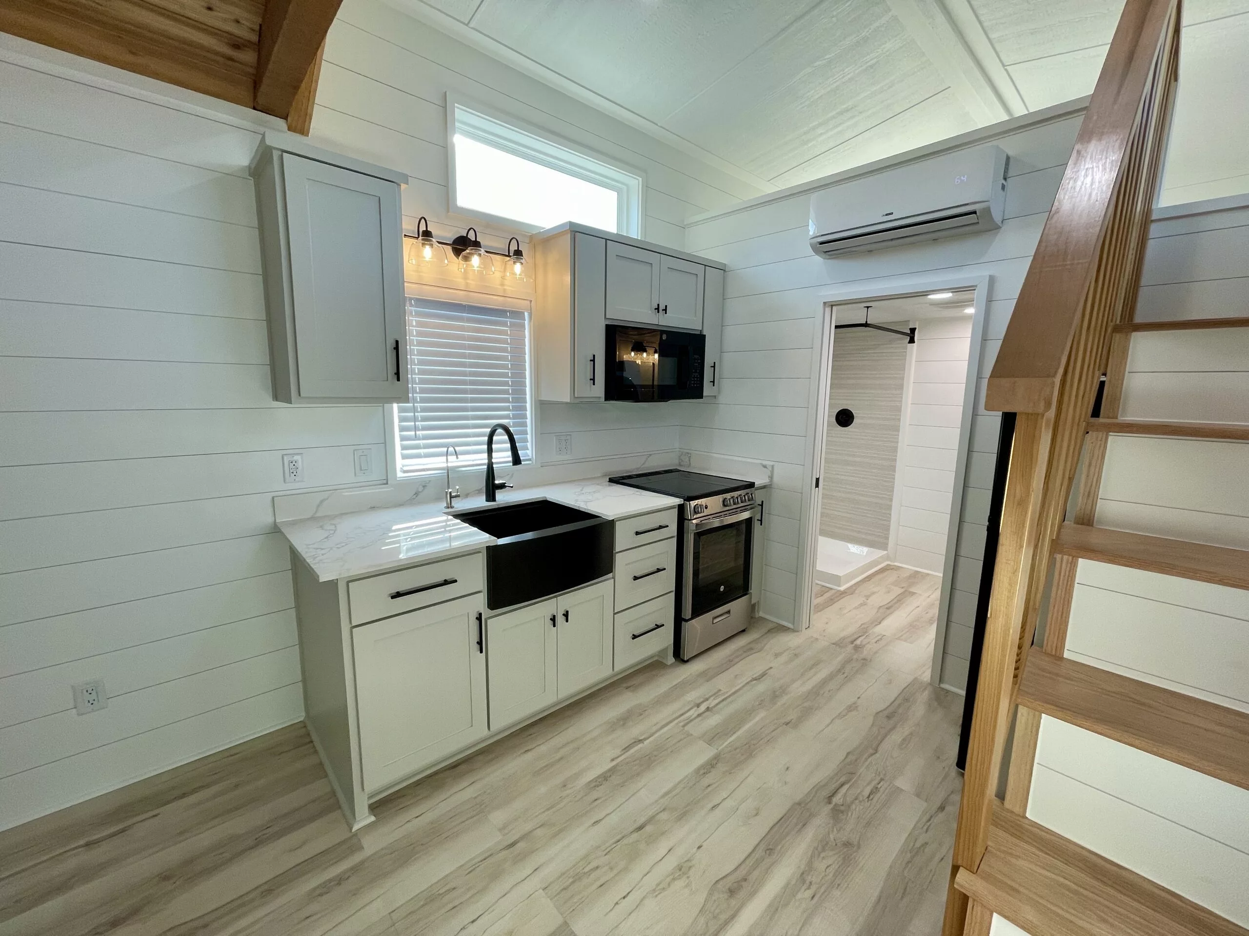 The New Chapter 's kitchen includes an oven and a propane-powered stove, a microwave, a sink, and a fridge/freezer