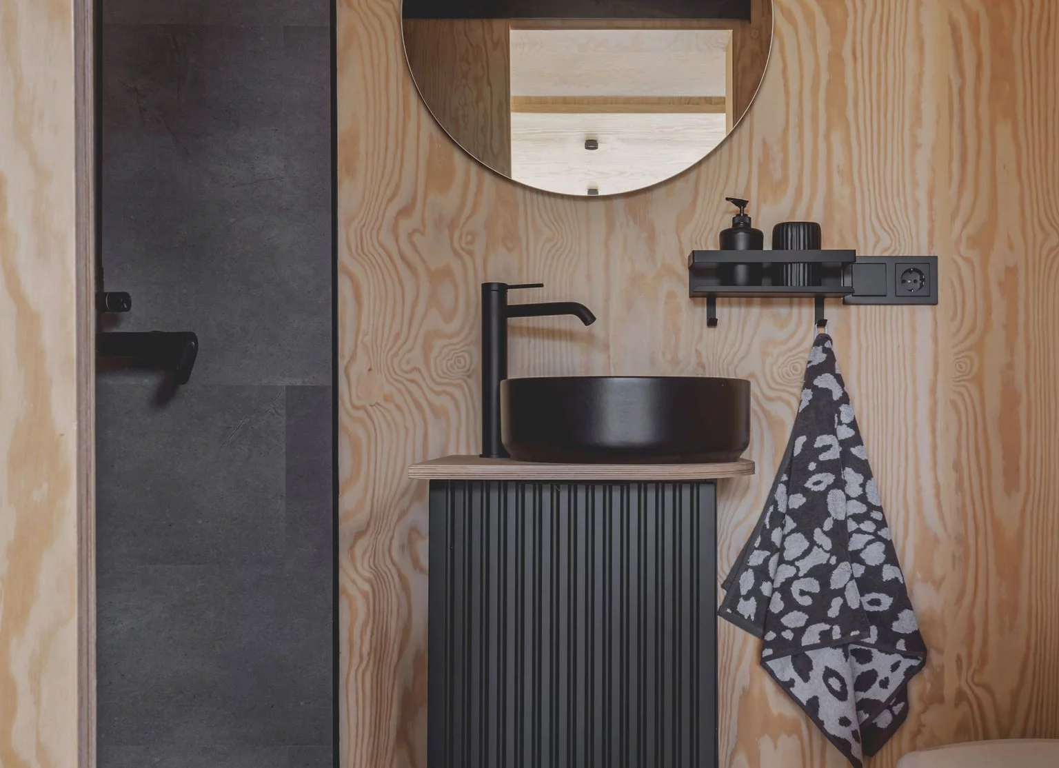 The BTH Loft off-grid's bathroom includes a sink, shower, and a composting toilet