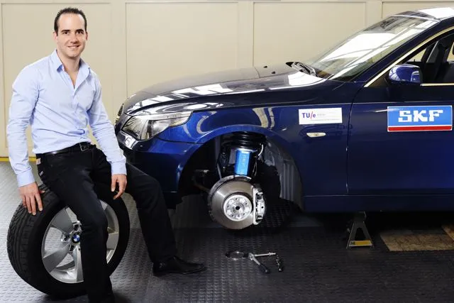 Eindhoven University researcher Bart Gysen and a test car fitted with the new suspension system