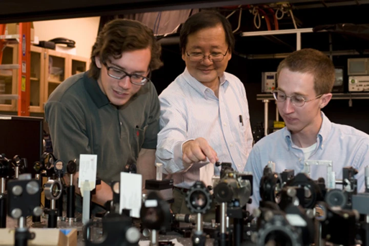 WSU chemist Choong-Shik Yoo, seen here with students, has used super-high pressures to create a compact, never-before-seen material capable of storing vast amounts of energy (Credit: WSU)
