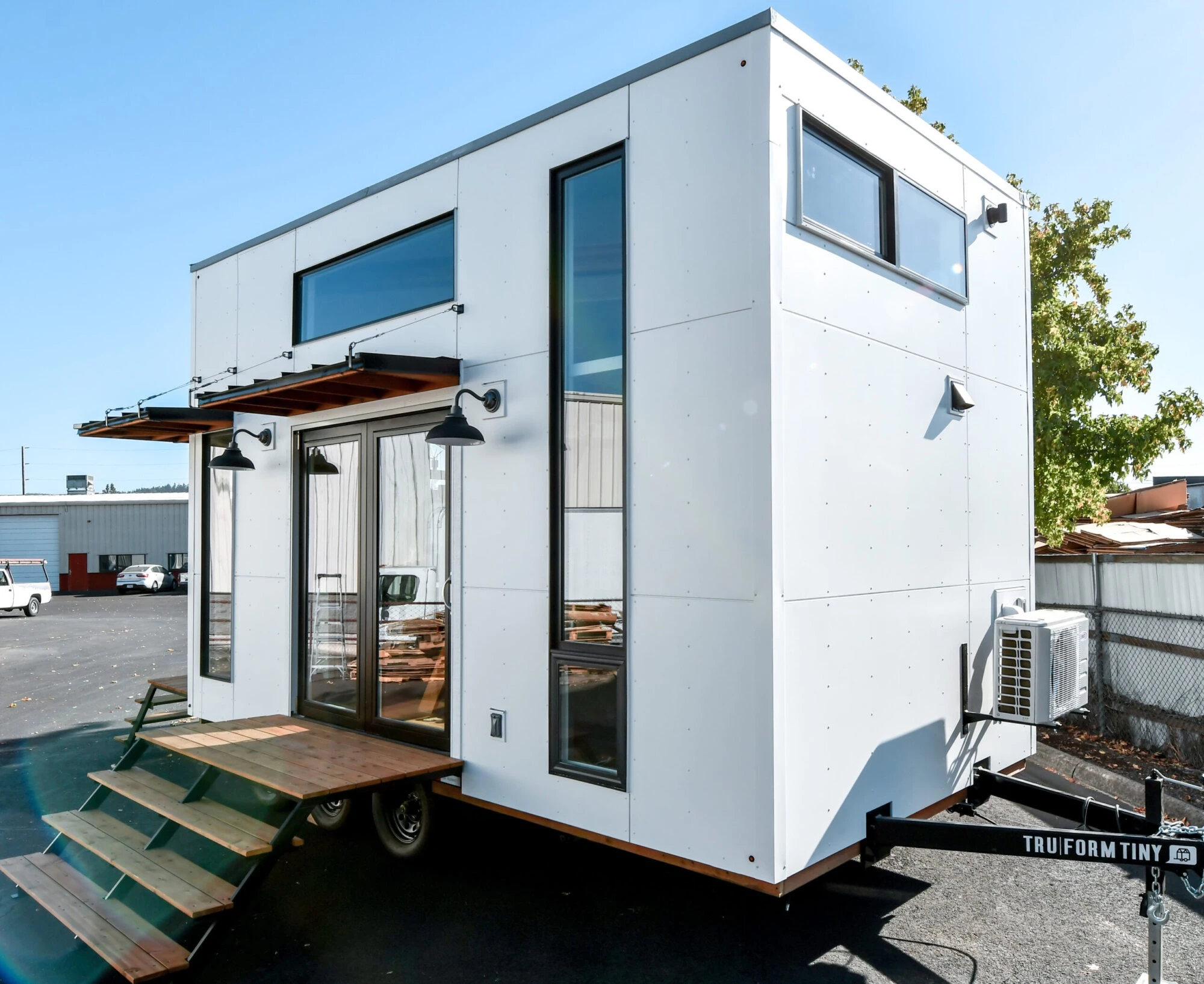The Urban Park Studio example model shown includes two entrances. The main entrance consists of double glass doors, while the smaller secondary entrance is a single glass door. Both enter into the kitchen