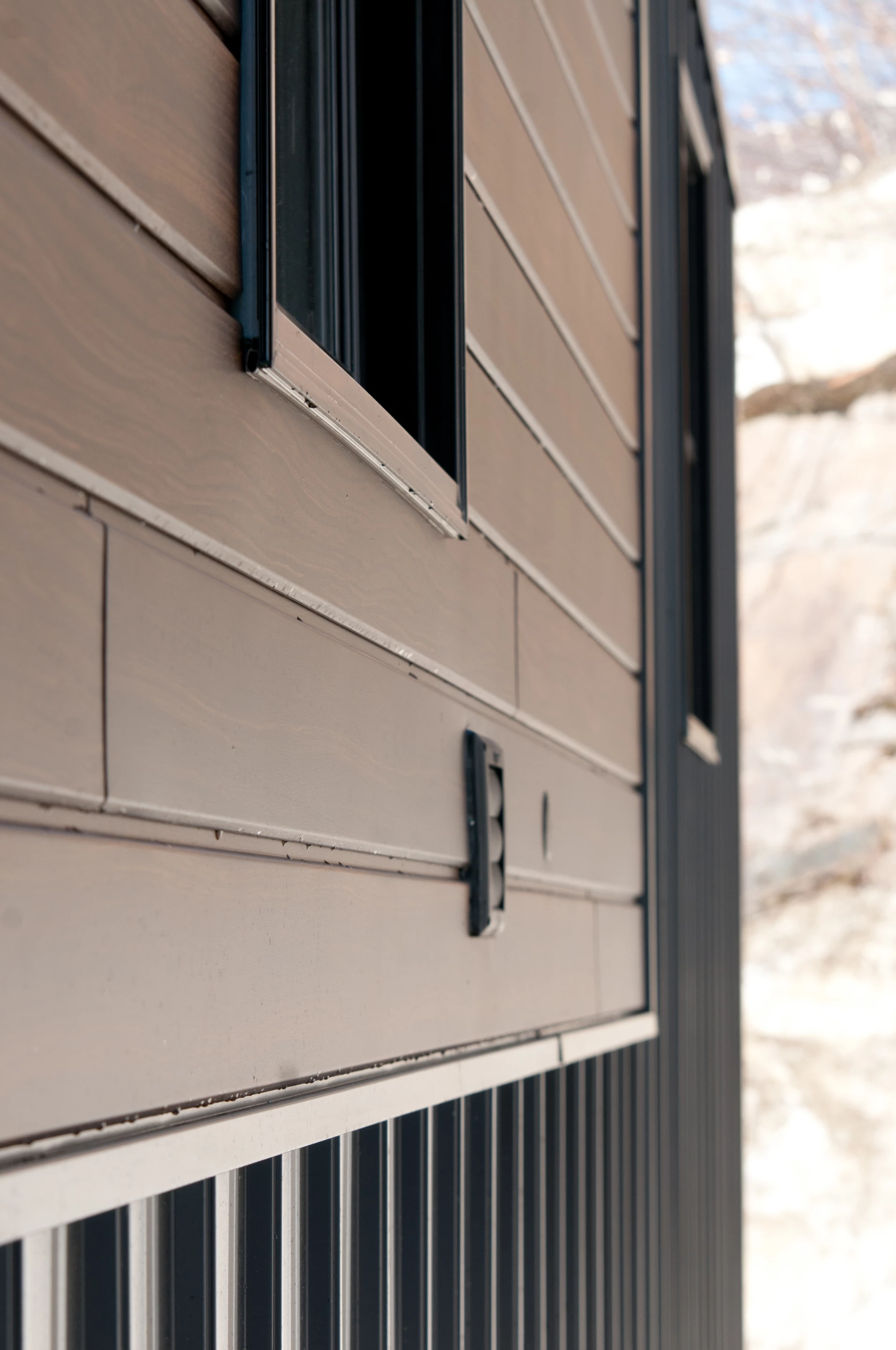 The Nomad is finished in vertical steel sheets and faux wood steel