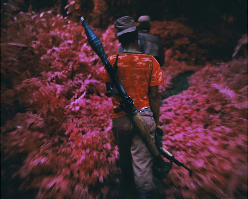 Richard Mosse's amazing series "Infra" depicts rebels in an African civil war using a discontinued military grade infrared film stock that adds surreal pink hues to a landscape devastated by violent conflict