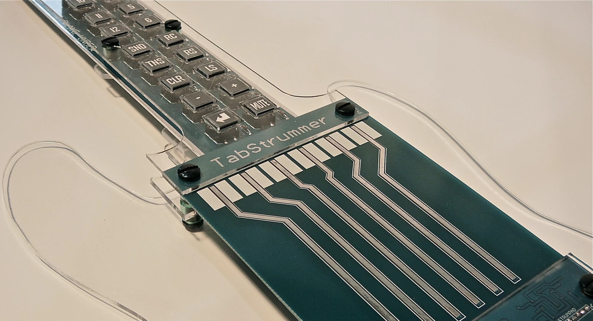The Tabstrummer's touch-sensitive printed-circuit-board (PCB) trace strings which are wide enough apart to enable individual picking as well as full strumming