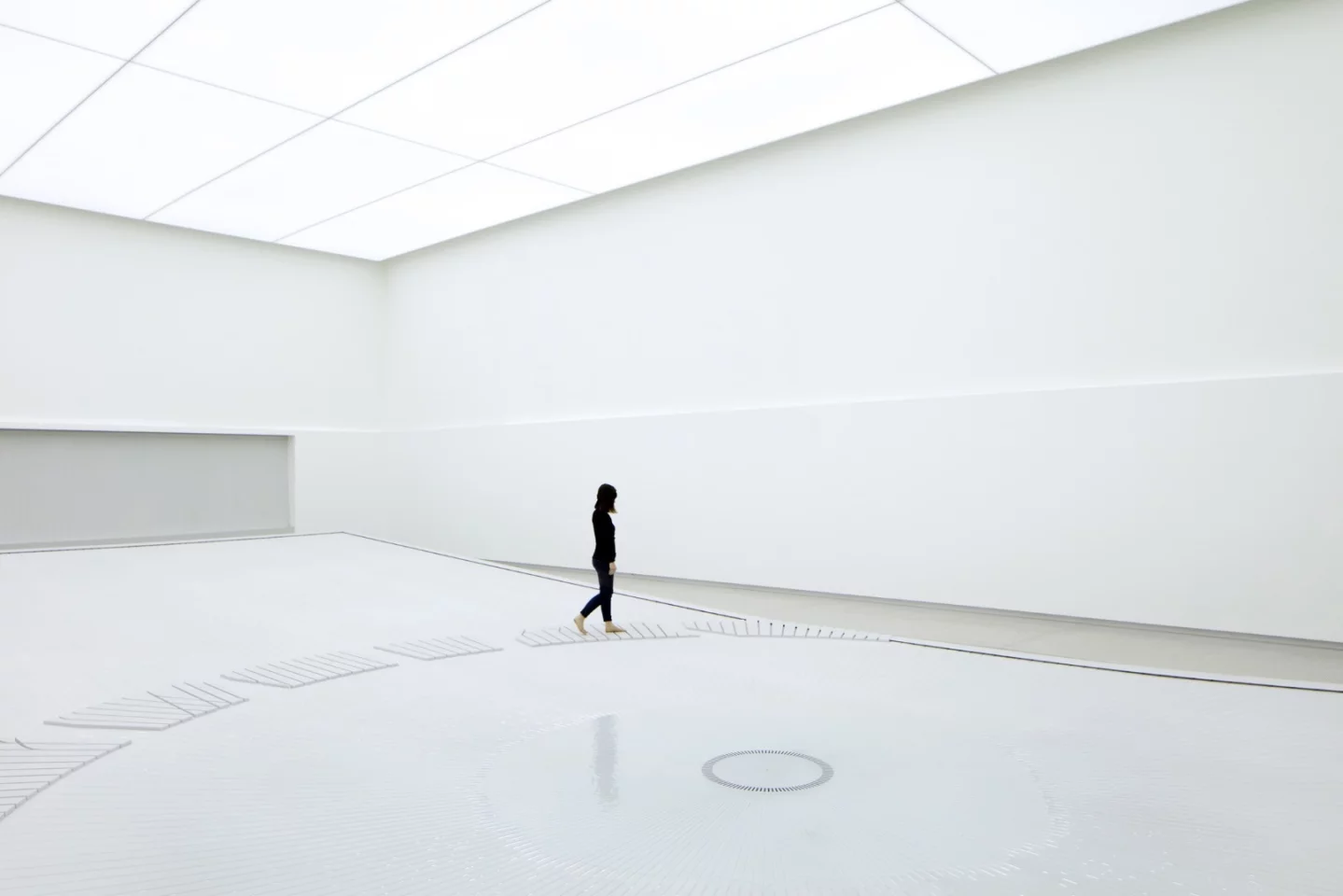 The water installation inside uses water droplets to create a visage resembling the sight of a giant city from space