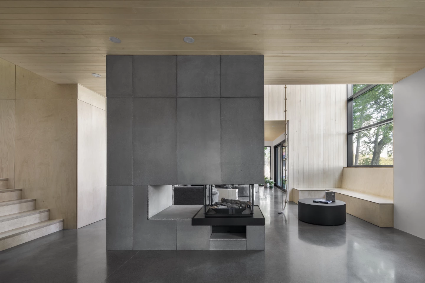 The Lakeside Cabin's interior is arranged around a fireplace and central atrium