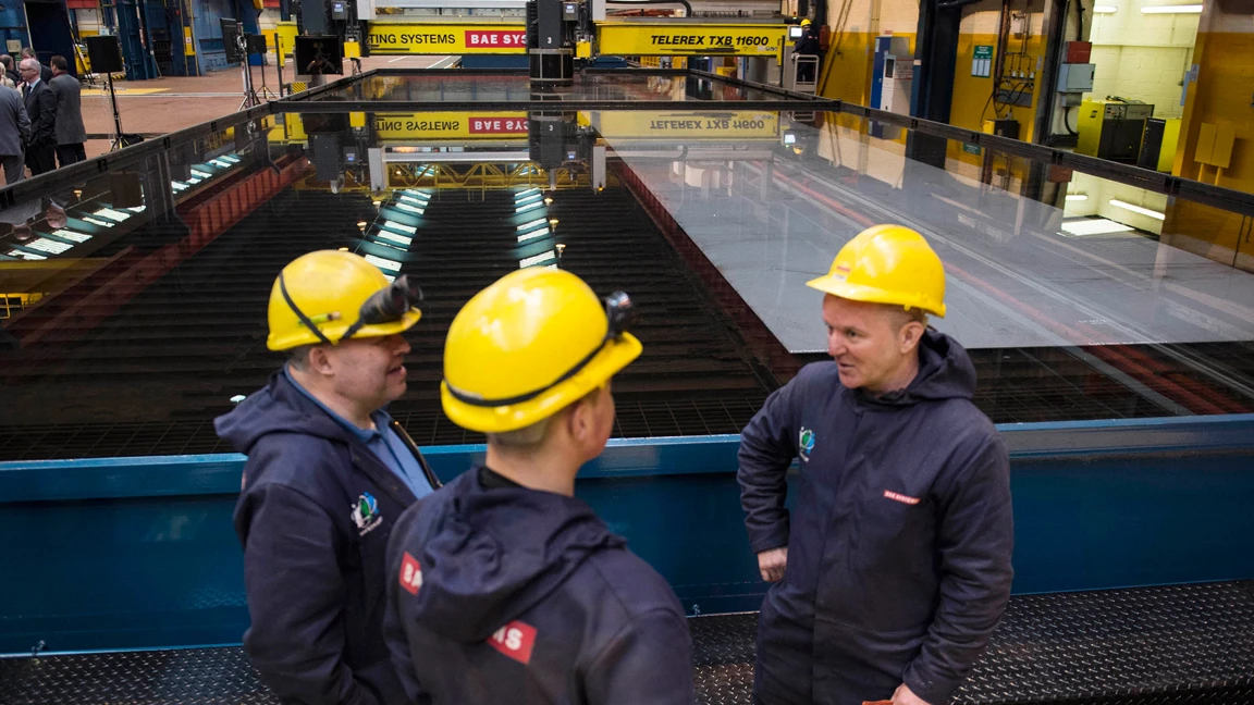 Workmen awaiting the first steel for the OPV being cut