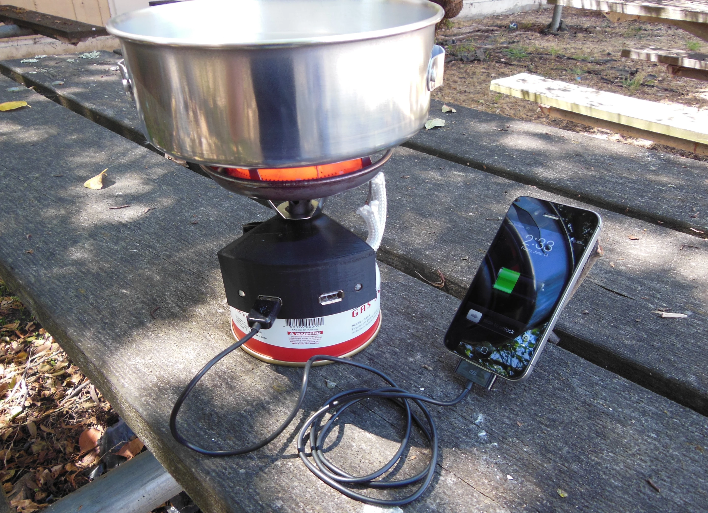 The Halo is a backpacking stove with built-in fuel cell charger for charging mobile devices