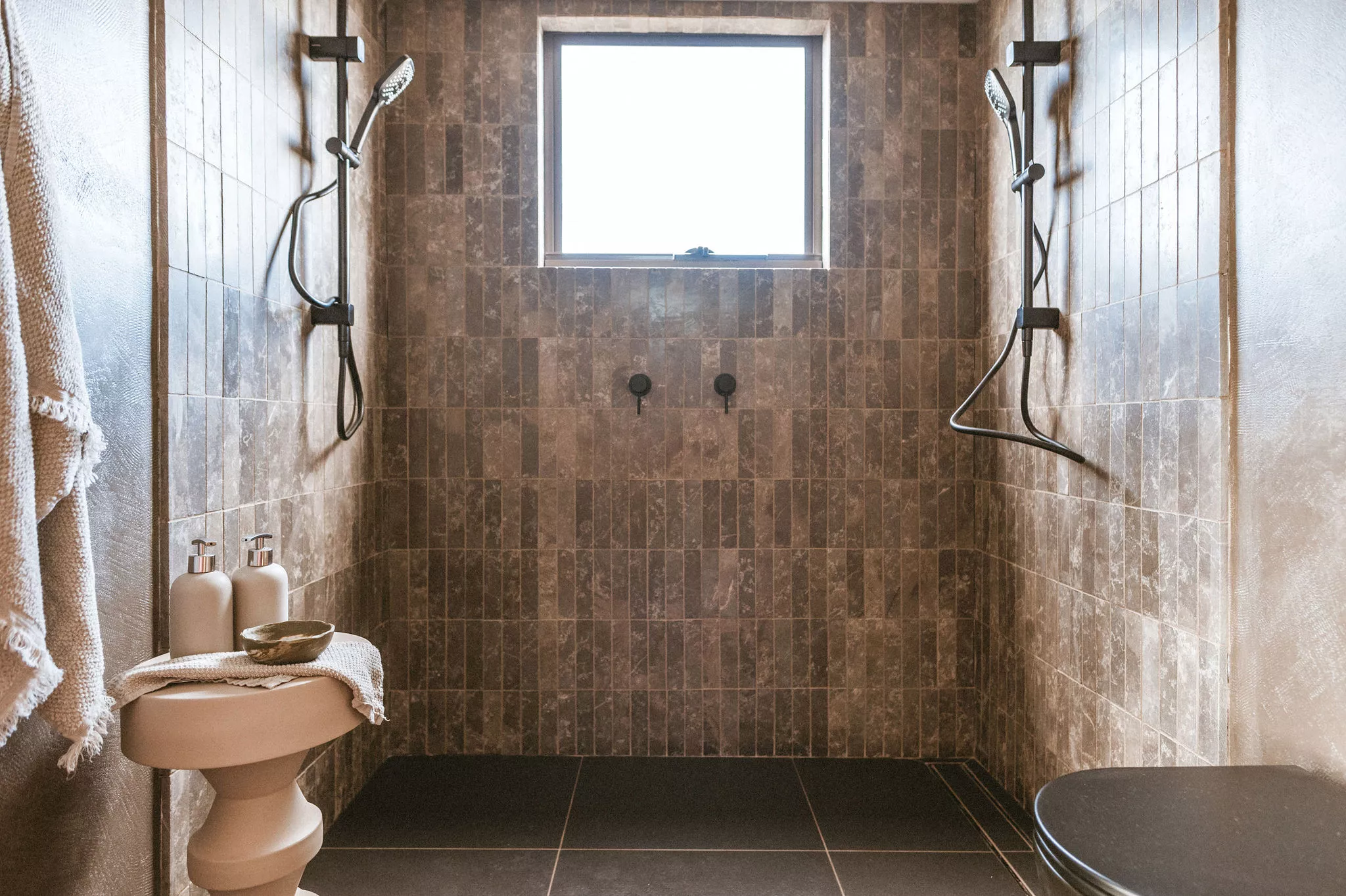 The Maldhi's bathroom looks quite luxurious for a tiny house and includes a double shower finished in handmade Moroccan tiles in clay