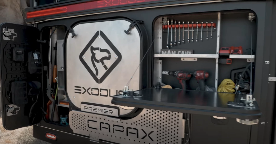 Around back, Exodus provides a mini-workshop with tools, work space and a tall gear cabinet - the badged silver plate in the middle is the spare tire cover that becomes a small side table