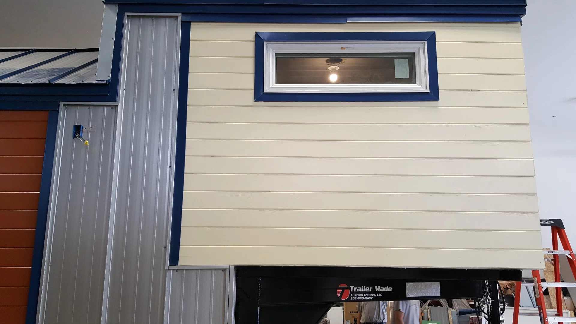 The Artist is clad in tongue and groove siding with metal accenting and roof