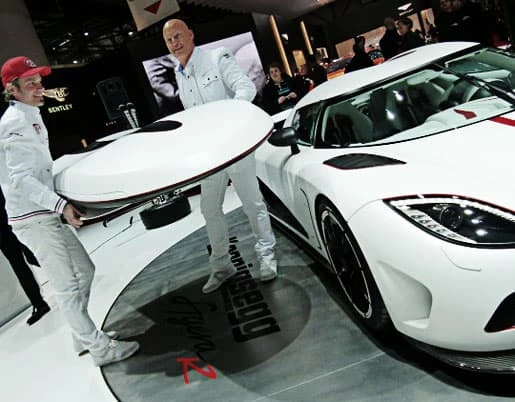 Christian von Koenigsegg and crew attach the roof box panel to the Agera R at Geneva 2011