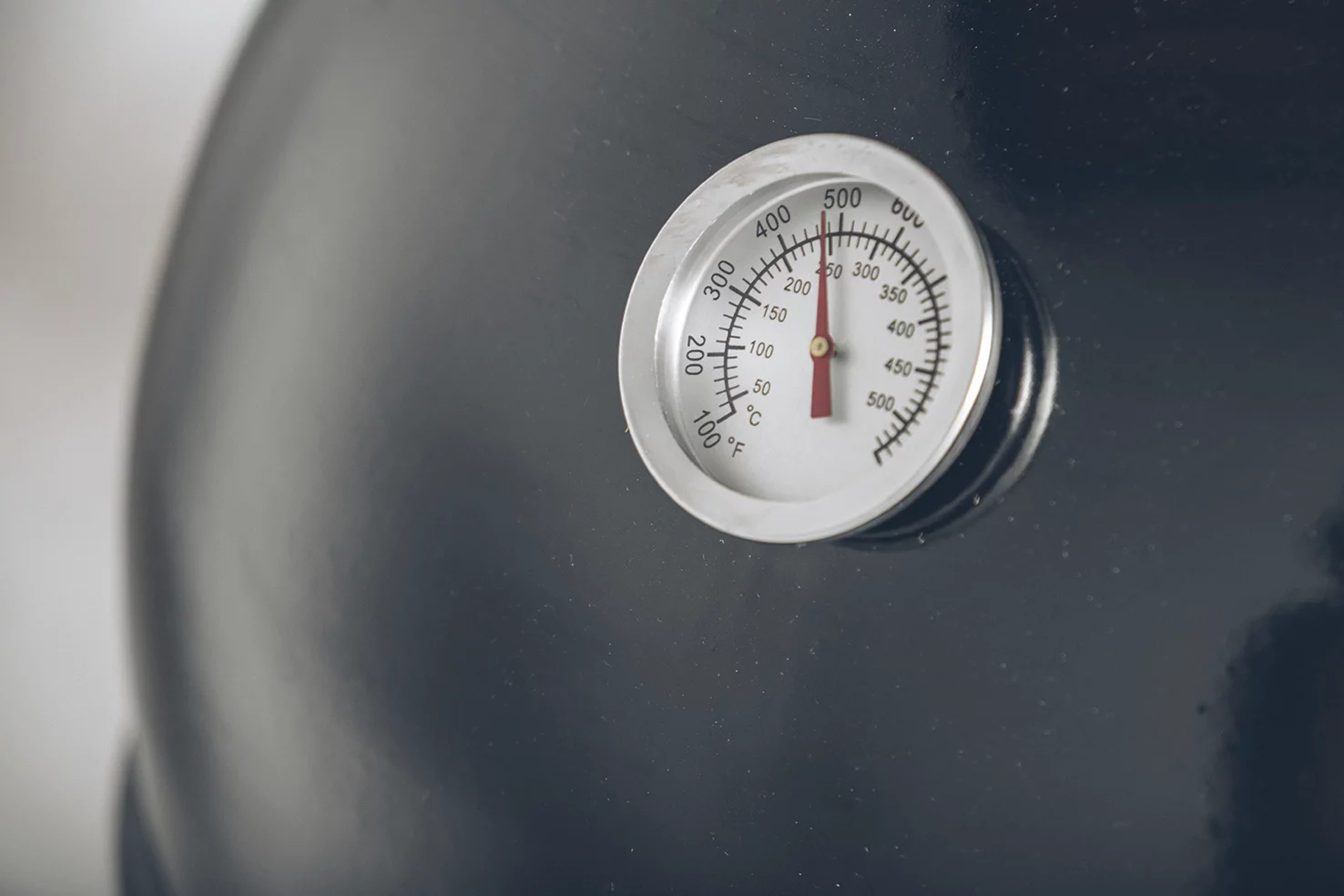 Additional features include a thermometer for accurate cooking