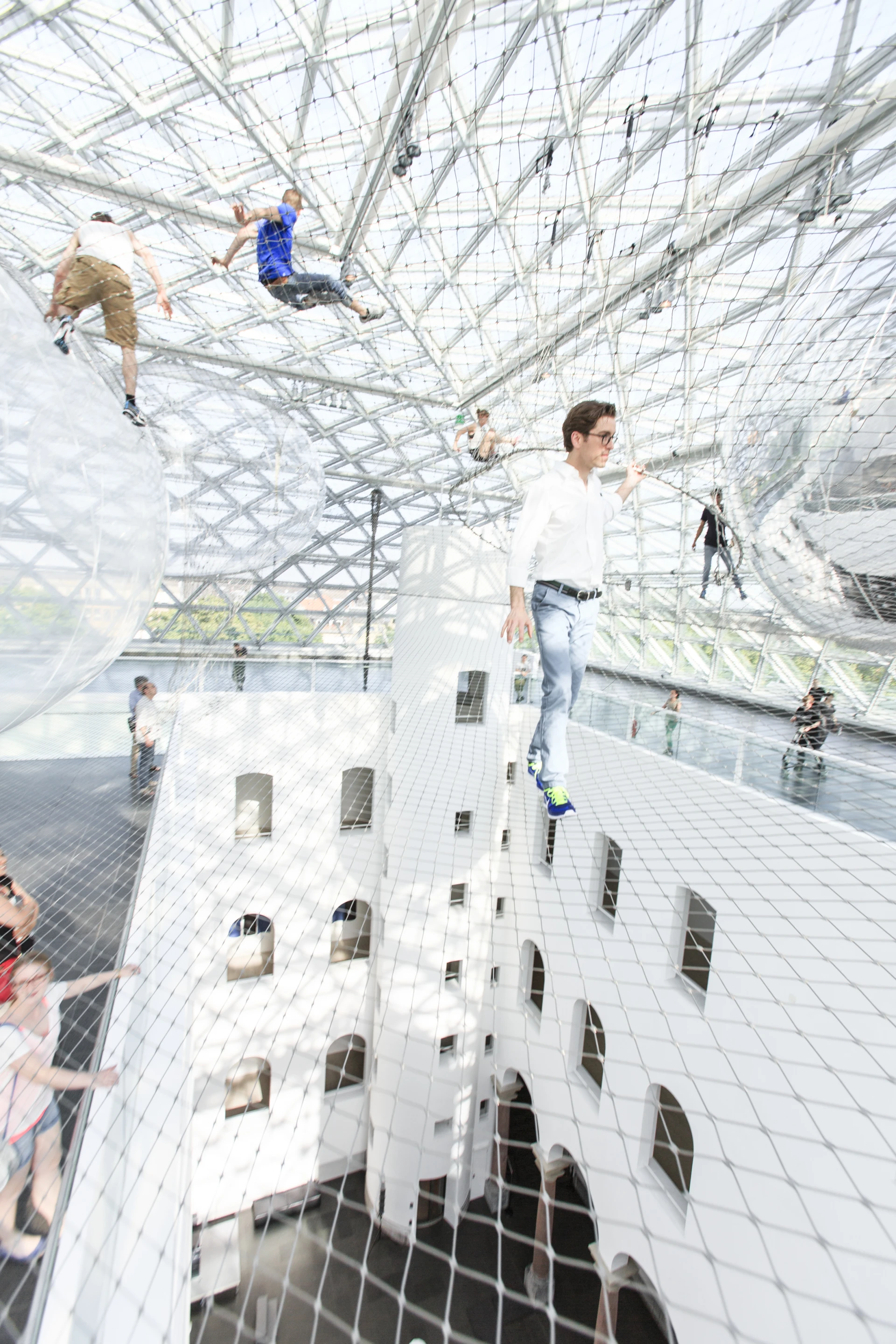 Safety regulations mean that up to ten adults in stable shoes may walk among the nets at any one time (Image: Studio Tomás Saraceno © 2013)
