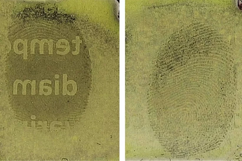 A fingerprint that was applied to a sheet of paper before text was printed onto it (left) as compared to one that was applied to text that had already been printed (right)
