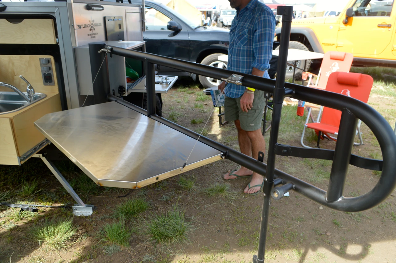 The Turtleback at Overland Expo included the optional spare tire mount with drop-down table