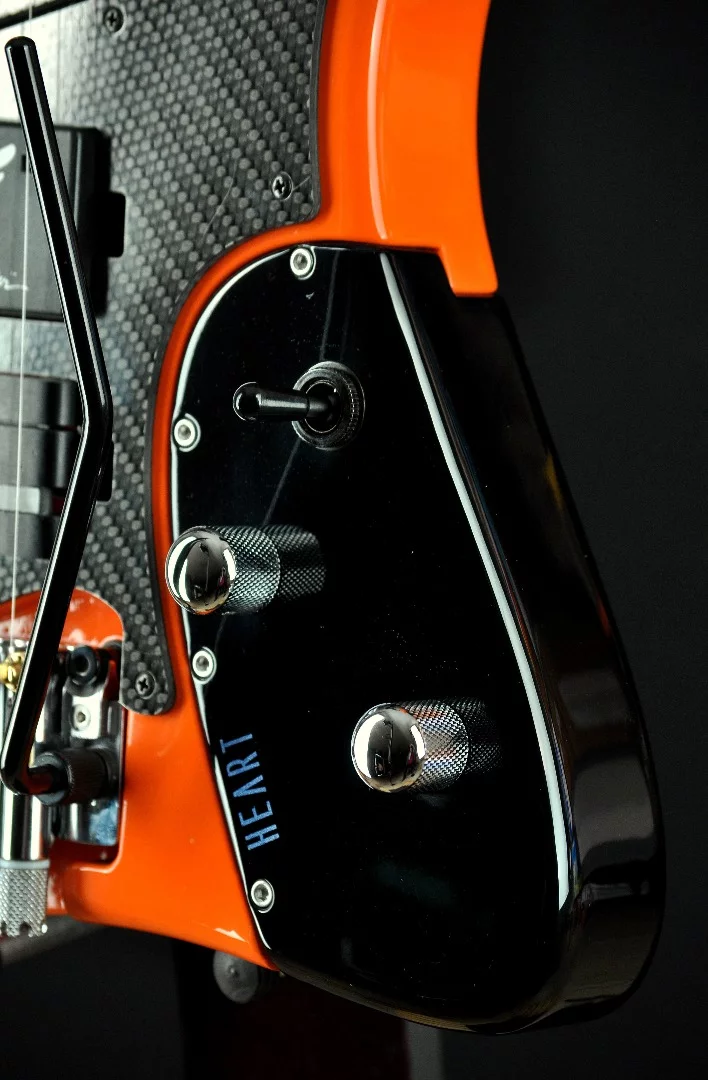 The pickup selector and volume/tone controls are included on a blackened alder hearth section