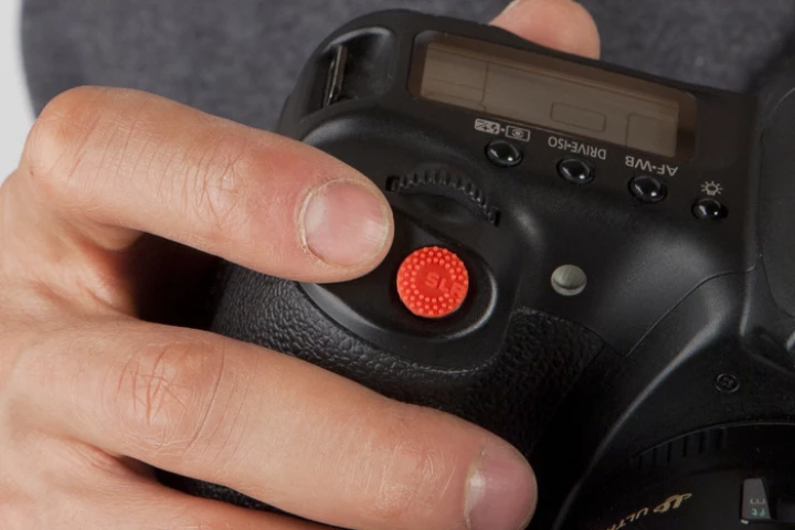 ProDot is an adhesive silicone dot which attaches to the shutter-button of your camera, and is said to make it more tactile
