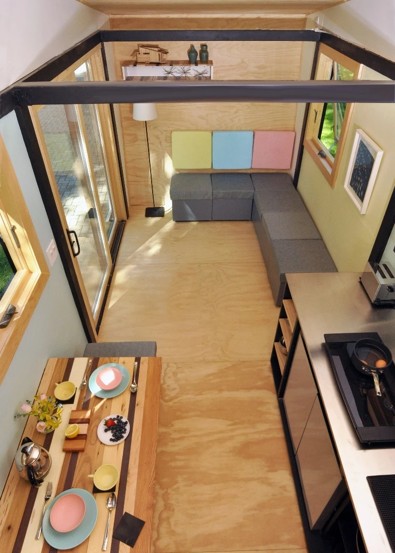 The interior features eight storage cubes which can be arranged to form a couch, several separate seats, or a spare bed, as required