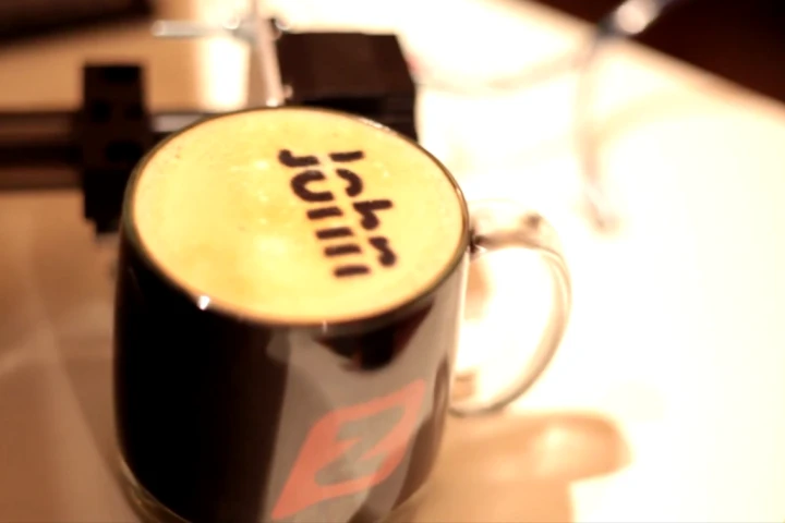 A start-up in Seattle has created the "Textspresso," a coffee machine that accepts and prepares specialized coffee orders via text message and will soon also print directly onto the coffee's top layer of cream