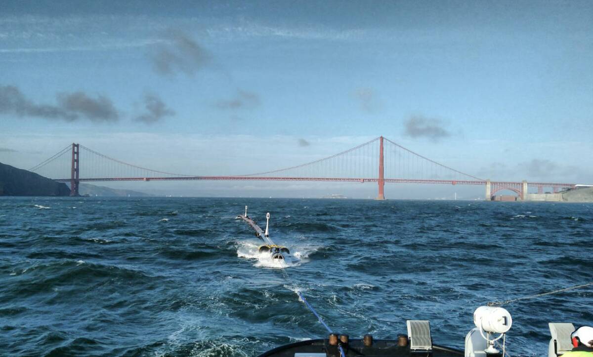 A 120-meter section of The Ocean Cleanup Project's barrier is towed out to sea
