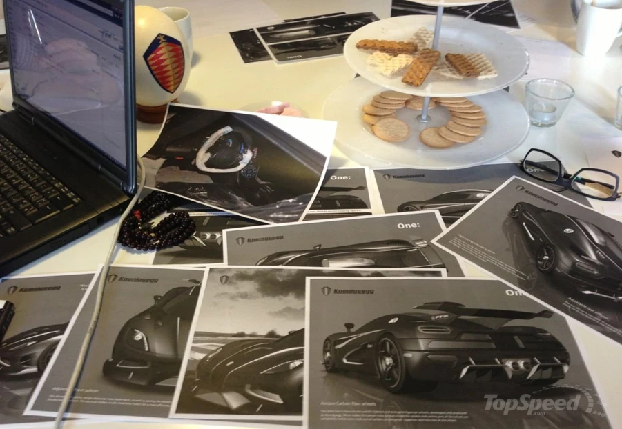 This image which confirmed the existence of the Koenigsegg One:1 appears on Top Speed and seemingly shows printed documentation and images of the new car on the coffee table at a private presentation.