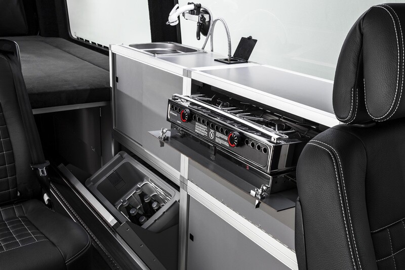 The dual-burner stove tucks away below the countertop
