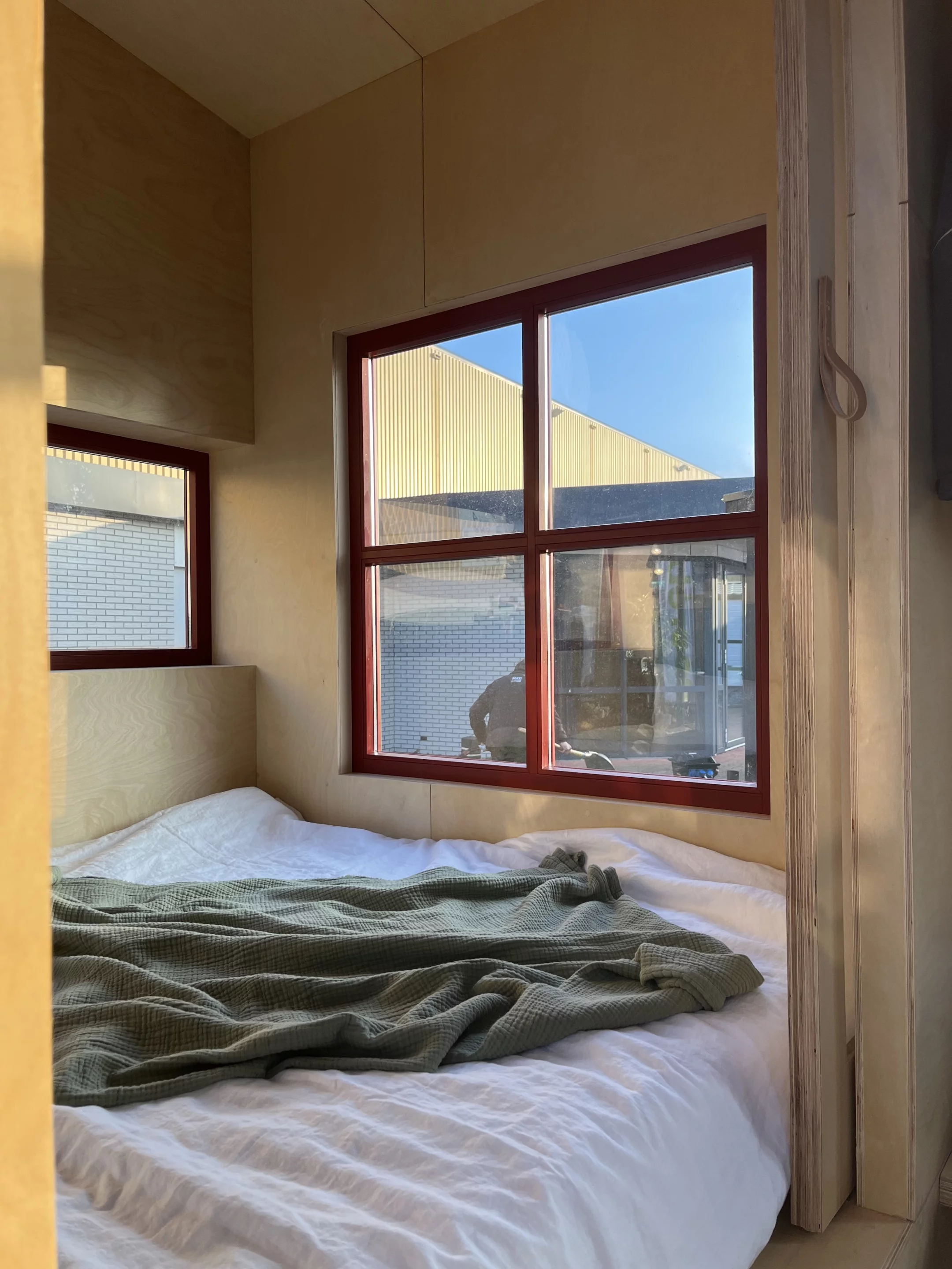 The THOW's bedroom features a double bed and some storage space