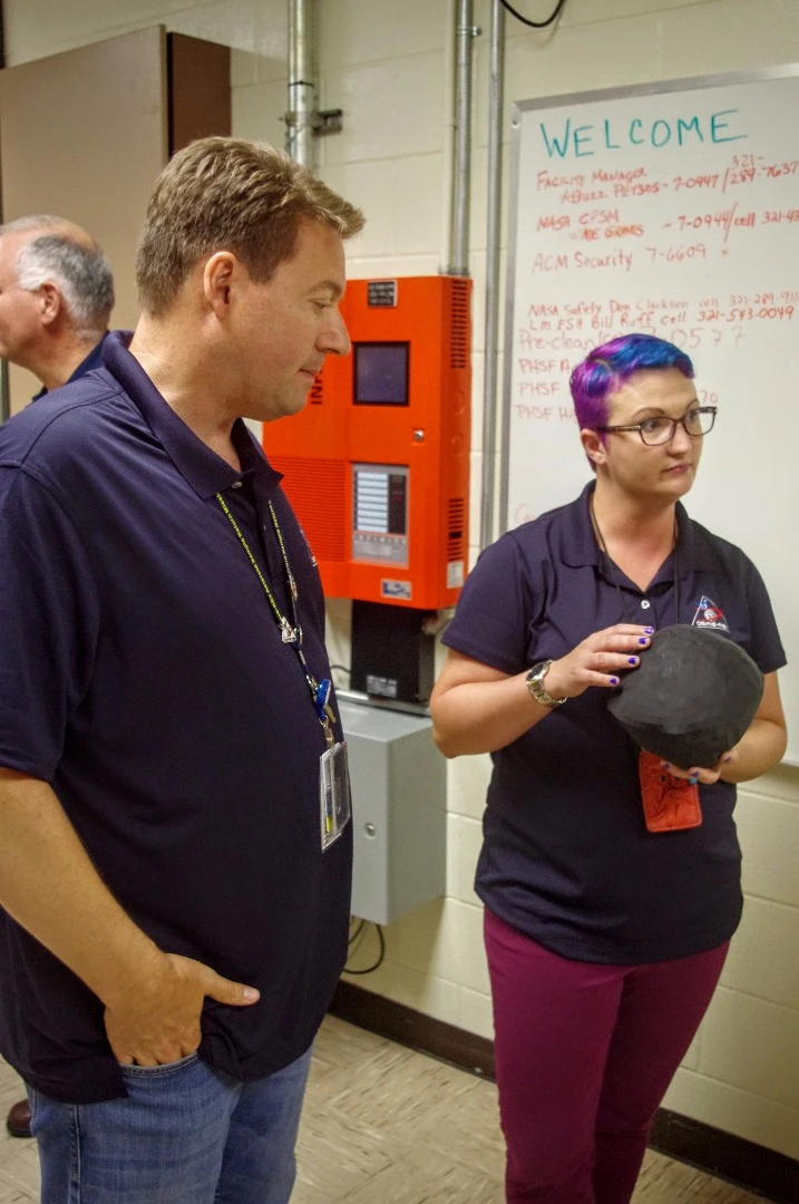 OSIRIS-REx deputy program scientist Christina Richey holds a model of Bennu during a briefing with John Dworkin, the mission's project scientist