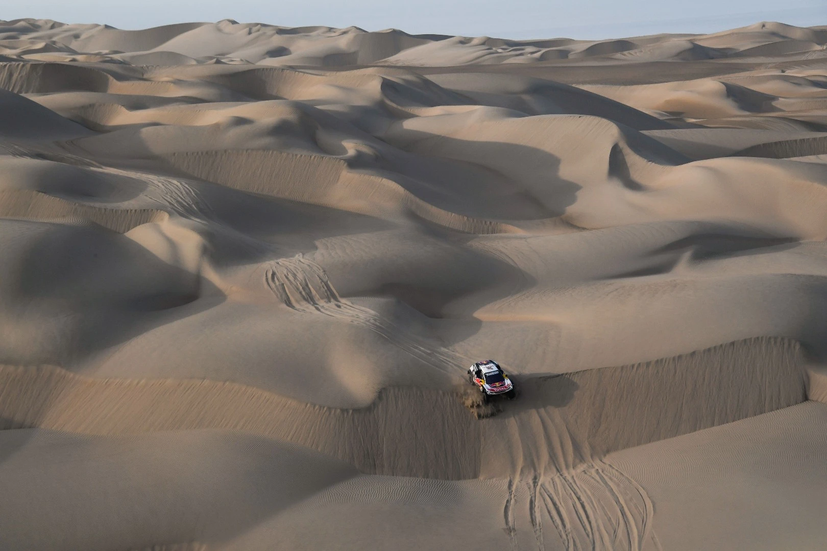 The terrain is unrelenting for Loeb and Elena as they push their Peugeot through Stage 5