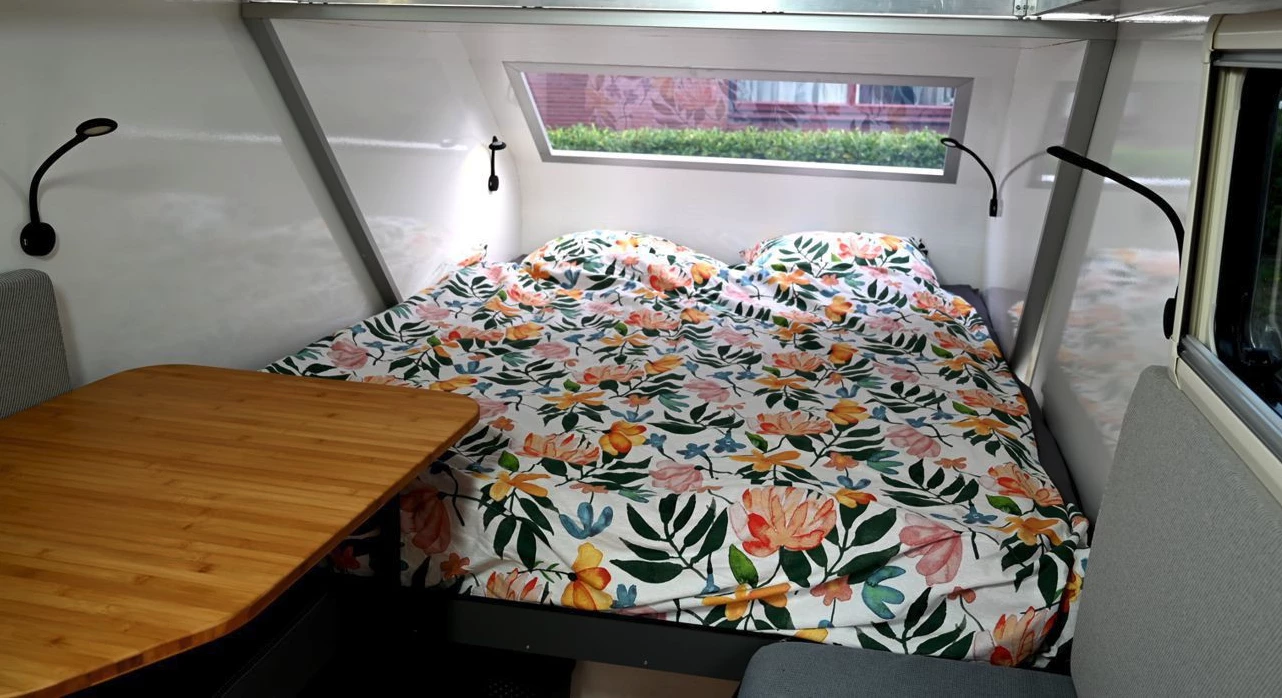 The slide-out makes room for a king-size bed and a separate dining lounge with slide-away bamboo table