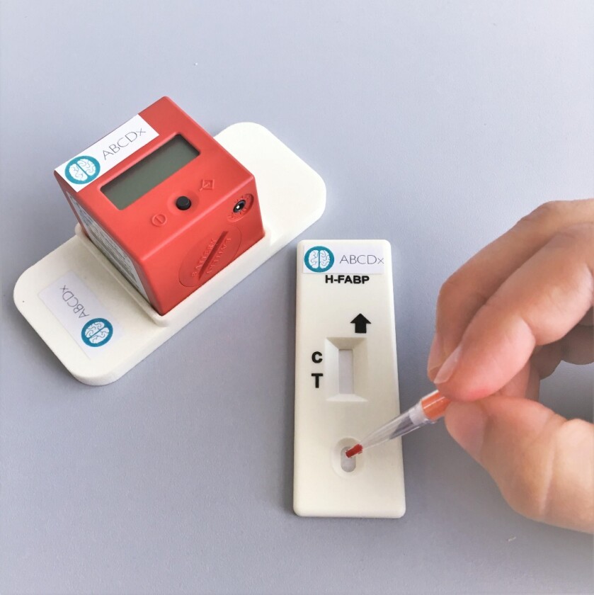 The TBIcheck in use, with the Cube Reader at left