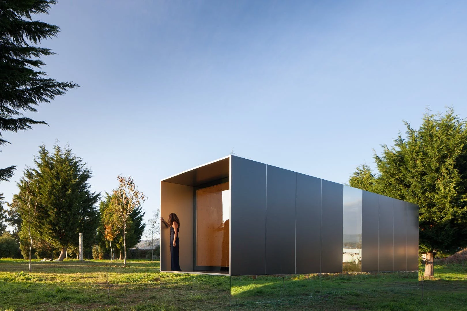 Portuguese prefabricated housing firm Mima Housing's Mima Light features a mirrored base section that makes it appear to float in mid-air