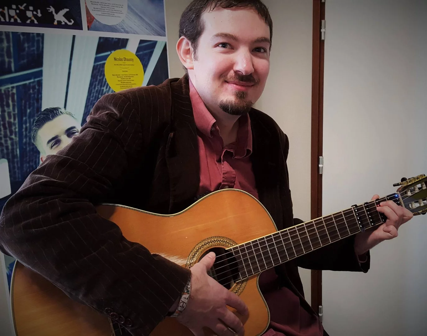 The student follows the light positions to fret a chord from a selected song