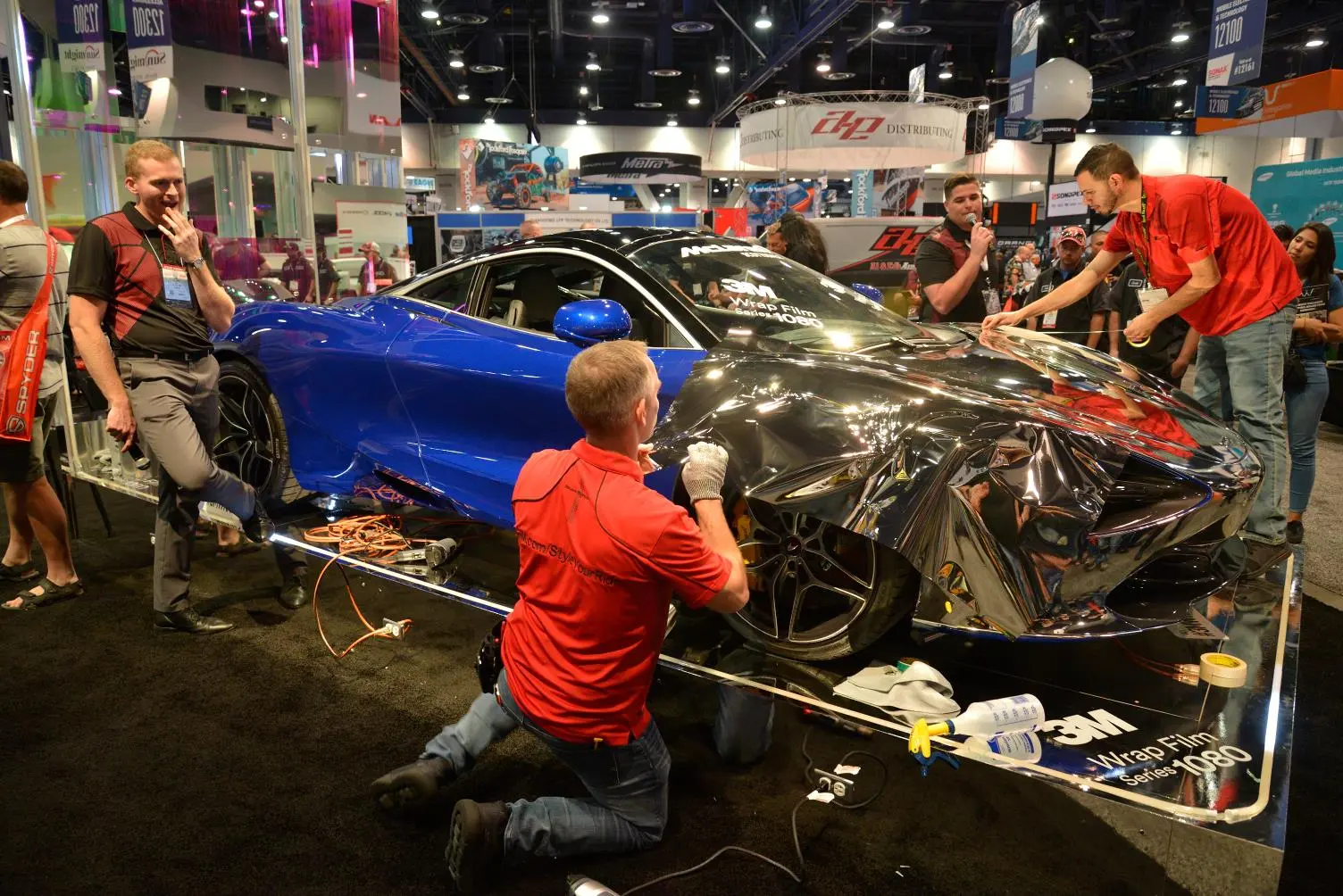 A study in applying one of many wraps on show at SEMA