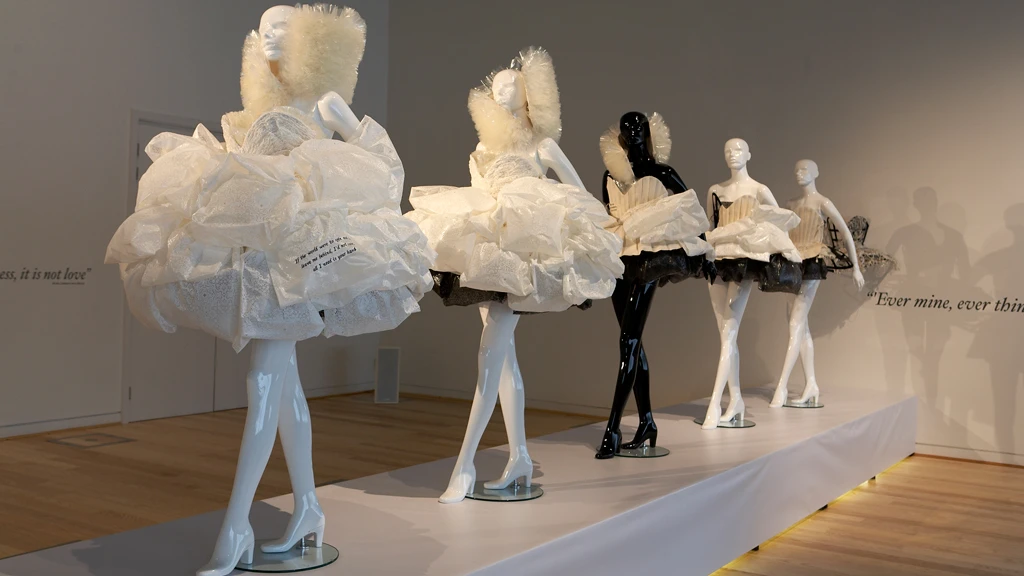 The five pieces show the transformation in stages from wedding dress to fashion garment and ultimately to dissolution