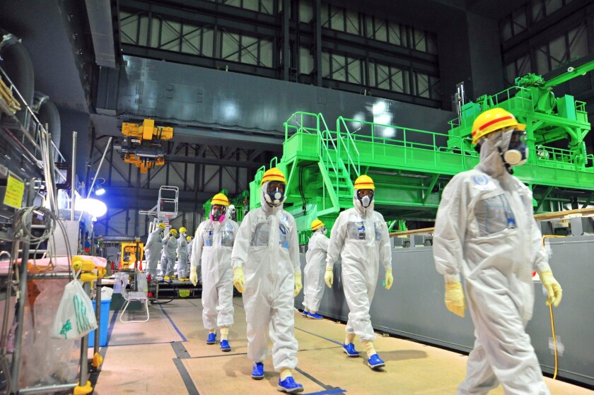 Experts from the International Atomic Energy Agency inspect reactor four at the Fukushima Daiichi nuclear power plant in 2013