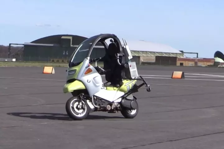 The AB Dynamics self-driving scooter is built on a BMW C1 scooter, fitted with outriggers, GPS gear, self-driving robotics and sensors