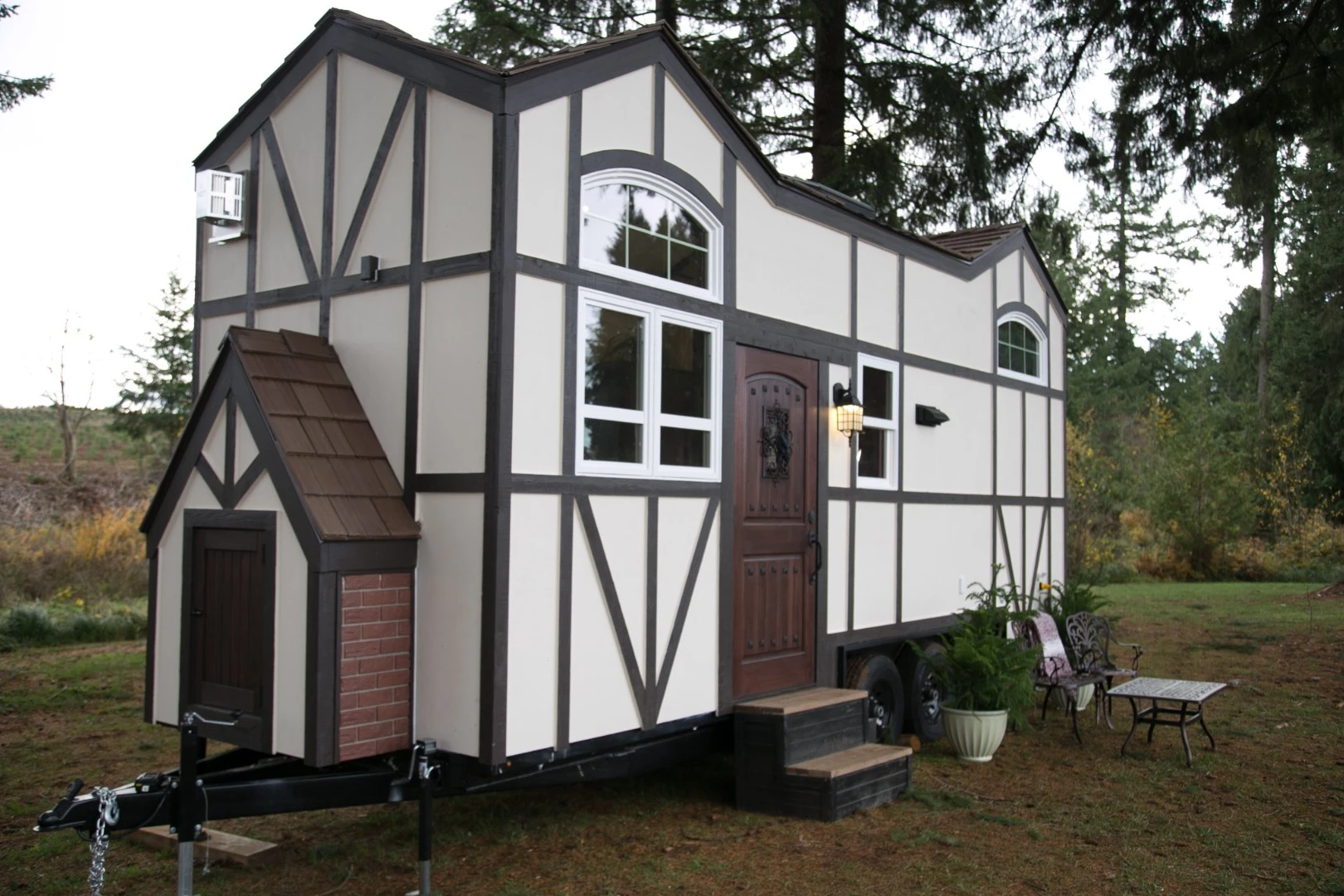 The Tudor-style tiny house's exterior features the distinctive half timbering Tudor style, but instead of stucco, Tiny Heirloom used plywood to achieve the effect