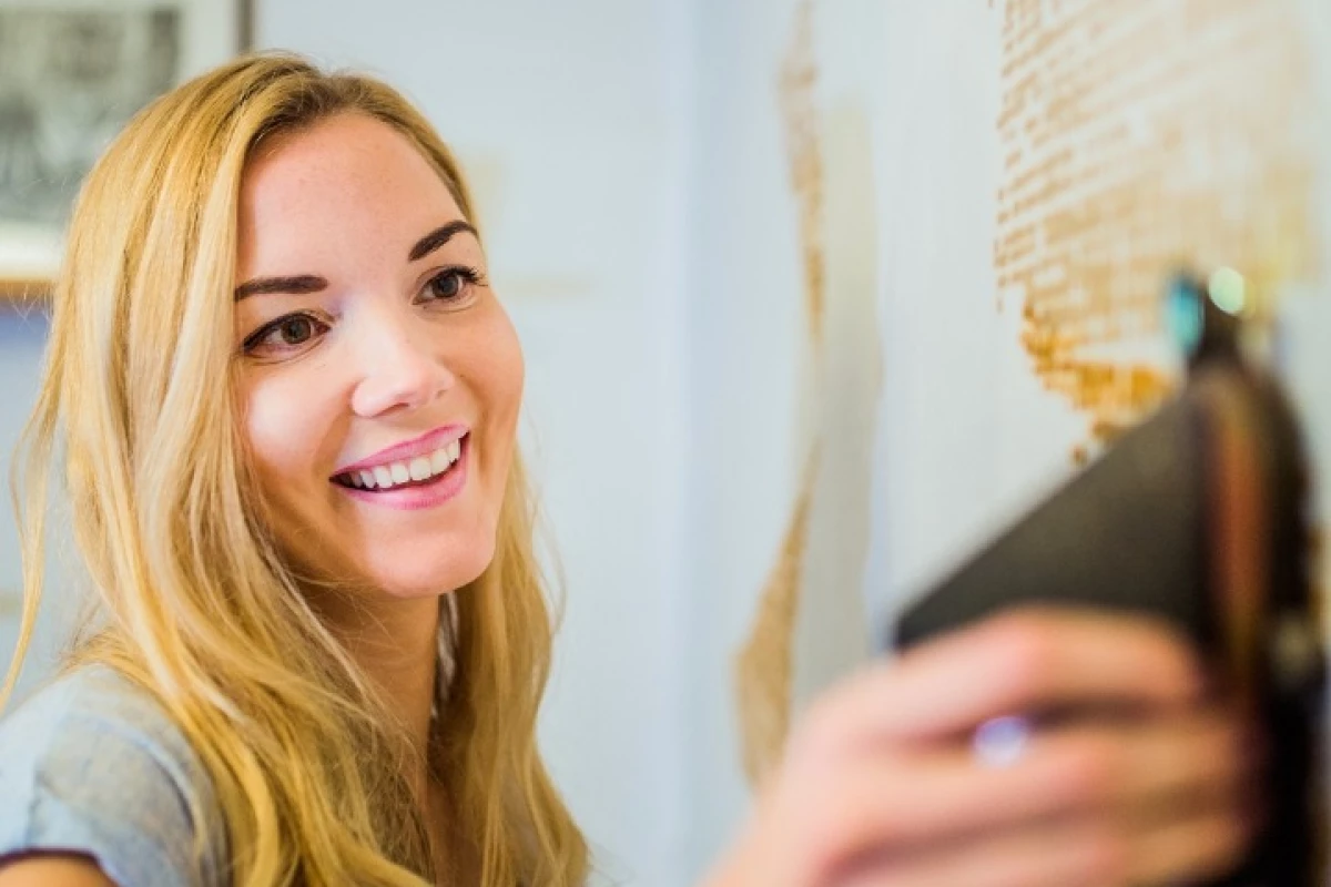 The app tracks the movement of the SprayPrinter in the user's hand using an LED on the device and then communicates to the device via Bluetooth when to spray and when not to