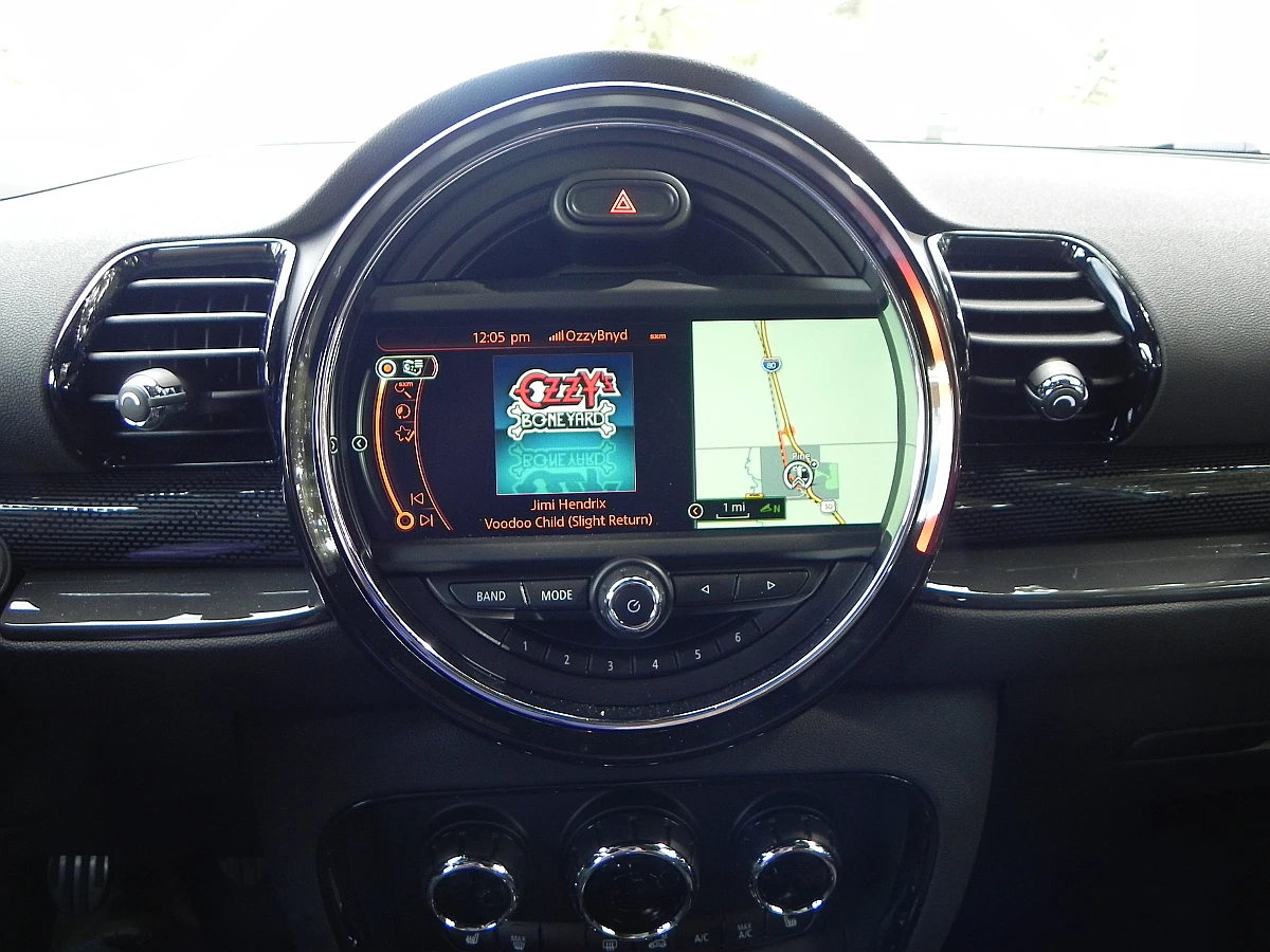 The large round bezel housing the infotainment screen dominates the center of the dashboard
