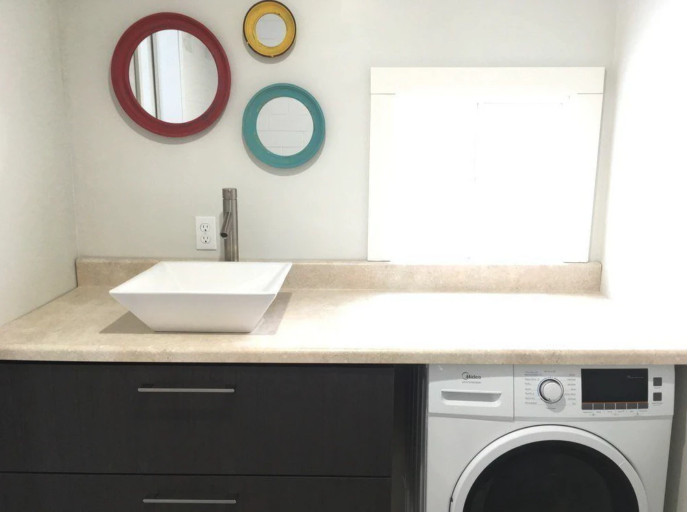 The Intellectual Tiny Home's bathroom features a washer/dryer