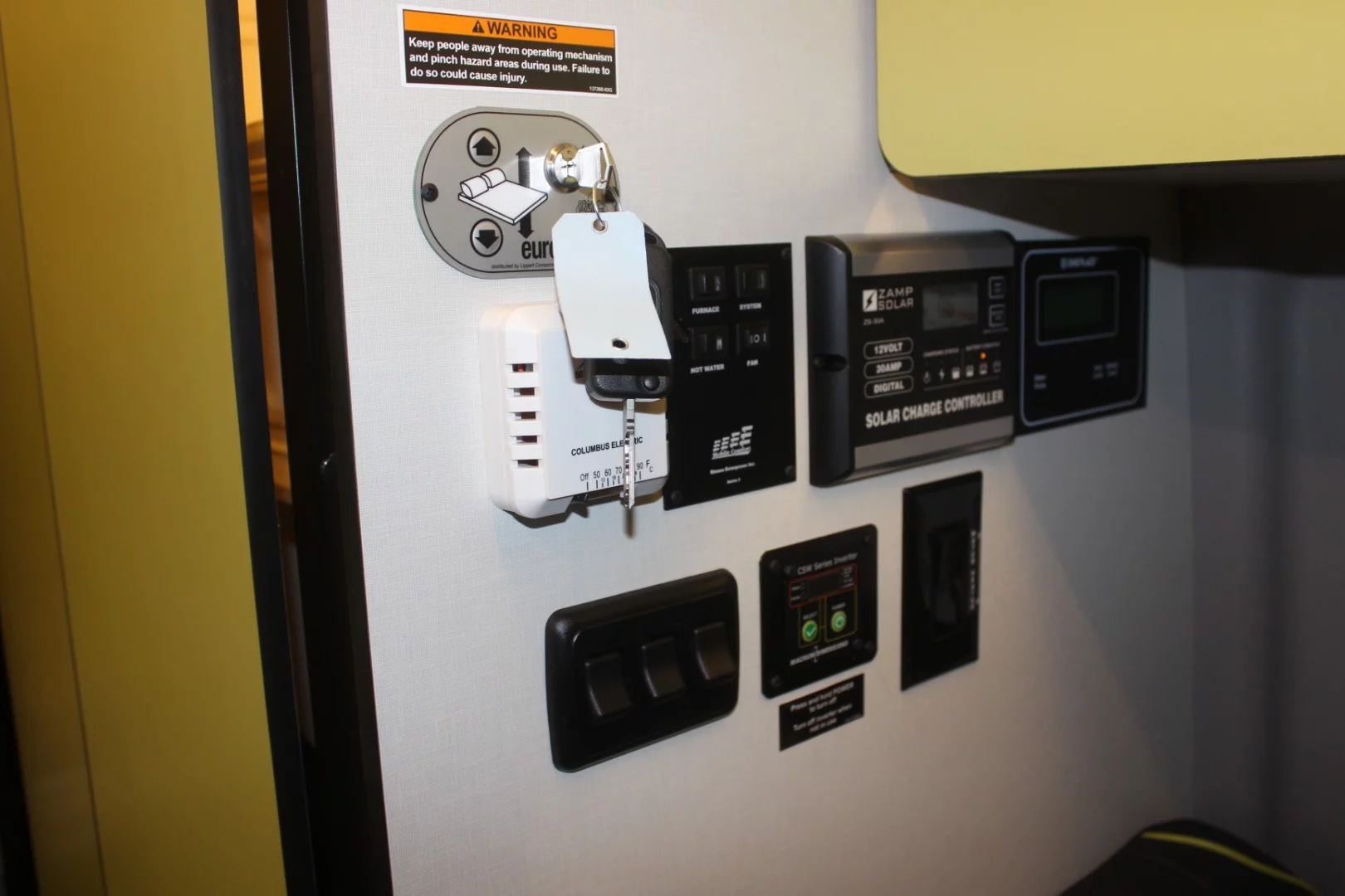 The Winnebago Revel's power-lift bed key, monitoring for the standard 200-watt solar charging system and other controls